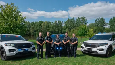 Meridian Township Police officers with three police vehicles