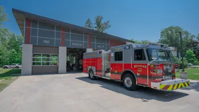Meridian Township's Central Fire Station with a fire truck parked out front
