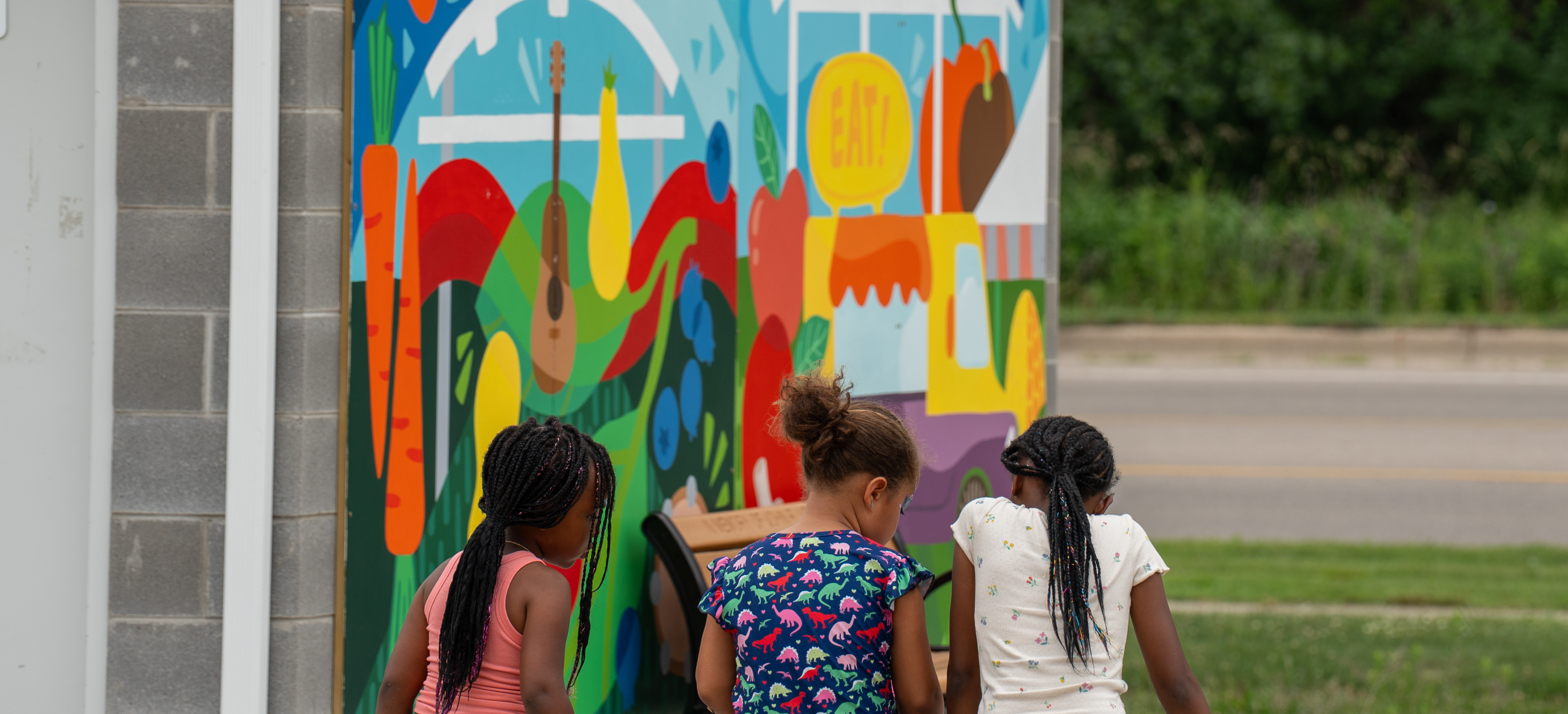 Young girls sitting together at Marketplace on the Green